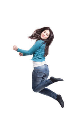 Jump of happy joyful young woman on whiteの写真素材