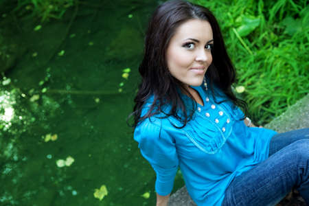 One happy beautiful young brunette woman outdoorsの写真素材