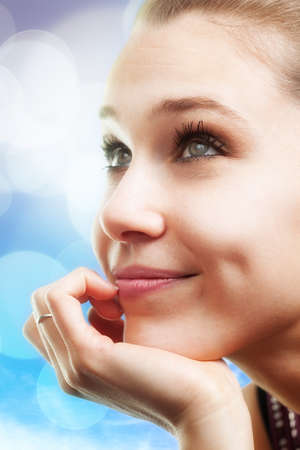 Bright portrait of pensive happy beautiful young womanの写真素材
