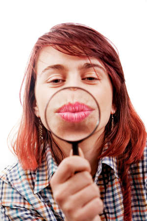 Kiss of funny girl and magnifying glassの写真素材