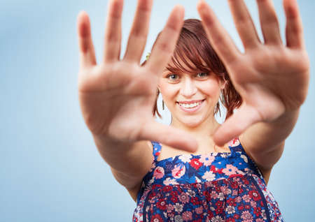 Happy playful teen girl looking through handsの写真素材