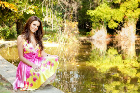 Elegant sexy beautiful woman with colorful dress outdoorの写真素材