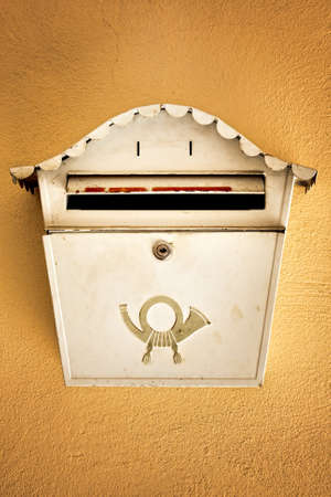 Old ancient mail box on brown wallの写真素材