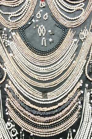 Many shiny decorative jewels at souvenir marketの写真素材