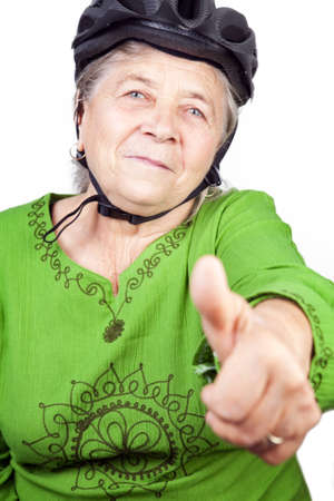 Confident old senior cyclist woman showing ok signの写真素材