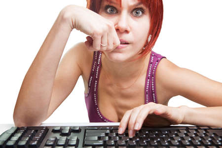Angry woman on computer surfing the webの写真素材