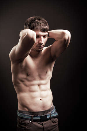 Sexy shirtless man with muscular abs over blackの写真素材