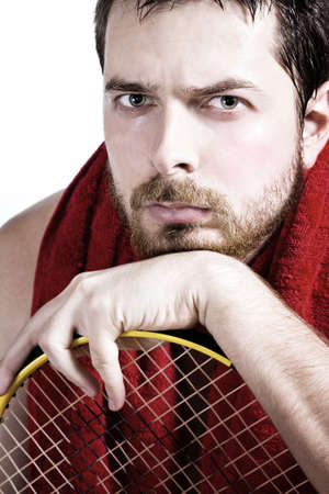 Portrait of tired male tennis player over whiteの写真素材