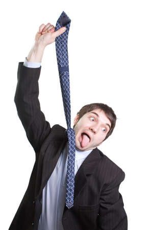 Depressed funny businessman hanging from a tie over whiteの写真素材