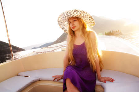 Beautiful elegant blond woman on luxury boatの写真素材