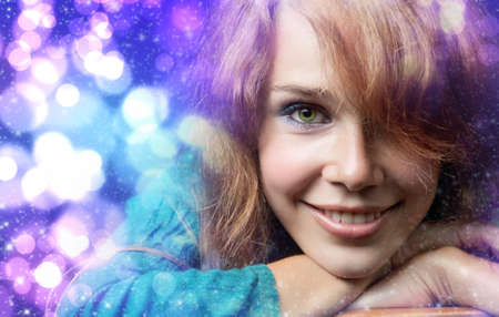 Colorful Christmas portrait of happy cute young womanの写真素材