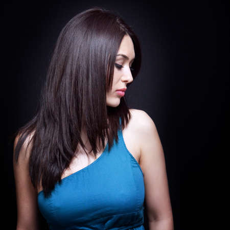 Sexy beautiful young brunette woman over blackの写真素材