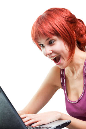 Happy woman surfing internet on laptop over whiteの写真素材