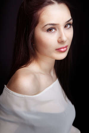 Beautiful sensual woman with lovely eyes over blackの写真素材
