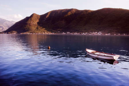 Peaceful view from Montenegro - boat, water and mountainsの写真素材