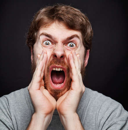 Scream of excited man making an announcementの写真素材