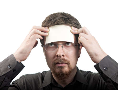 Man with blank note over his forehead isolated on white