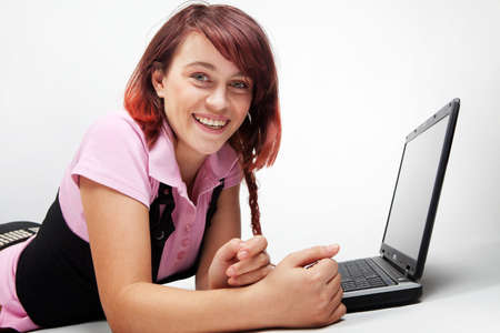 Happy teen student with her laptop over whiteの写真素材