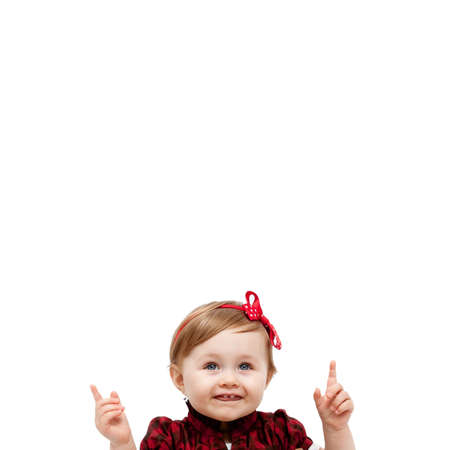 Isolated happy baby girl pointing up and aboveの写真素材