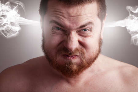 Stress concept - angry frustrated man with exploding headの写真素材