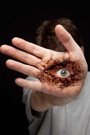 Eye on human hand - vision and identity conceptの写真素材