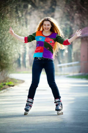 Happy young active woman on roller skatesの写真素材