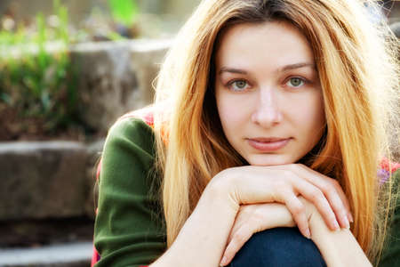 One young beautiful woman outdoor looking at cameraの写真素材