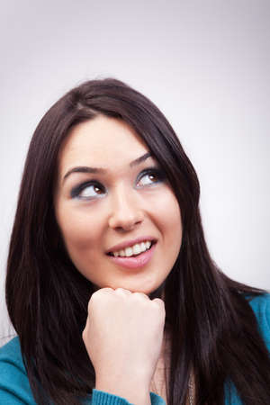 Portrait of cute pensive woman having happy thoughtsの写真素材