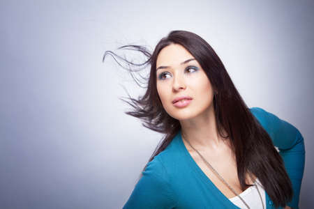 One young beautiful woman with hair in motionの写真素材