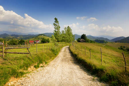 Rural landscape from Romania - village road and grasslandの写真素材