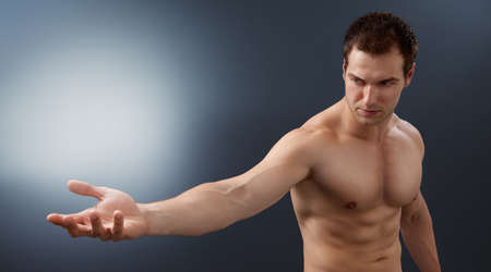 Light and power concept - creative muscular man holding bright sphereの写真素材