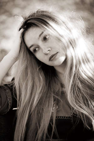 Sad depressed young woman in sepia styleの写真素材