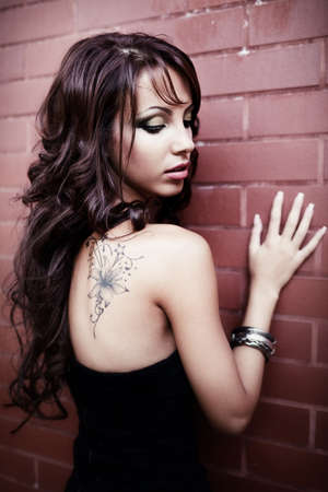 One sensual woman with sexy tattoo on her backの写真素材