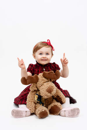 Happy baby girl with reindeer christmas present toyの写真素材