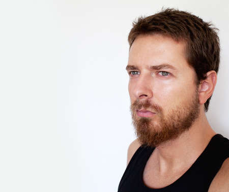 Face of pensive handsome man isolated on whiteの写真素材