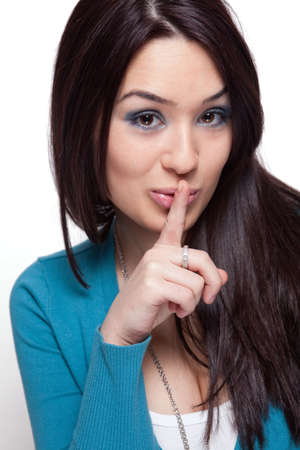 Cute funny young woman keeping a secretの写真素材