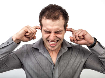 Too much noise or pressure concept - man covering ears for some silenceの写真素材
