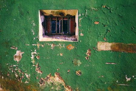 Broken window on old vintage wall from abandoned houseの写真素材