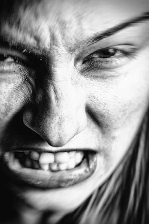 Face of stressed angry woman with scary expressionの写真素材