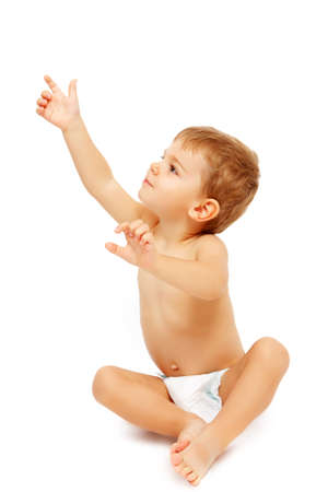 Baby boy in pampers pointing up, isolated on whiteの写真素材
