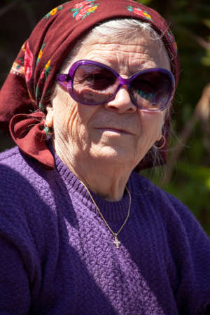 Funny senior woman with sunglasses outdoors