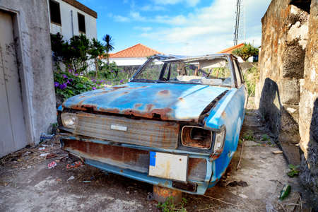 Rusty damaged car abandoned for metal scrapの写真素材