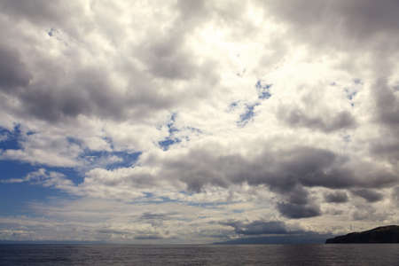 Clouds on the sky and sea waterの写真素材