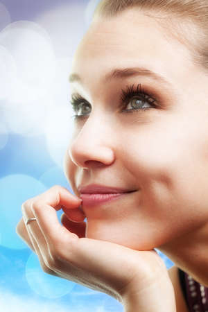 Bright portrait of pensive happy beautiful young womanの写真素材