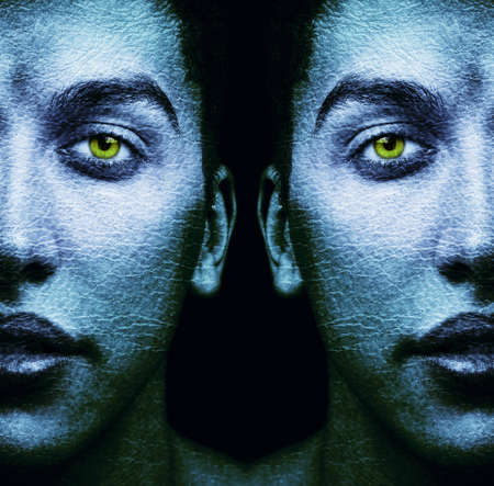 Textured faces of surreal male twins over blackの写真素材