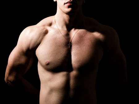 Shirtless man with muscular sexy body over blackの写真素材