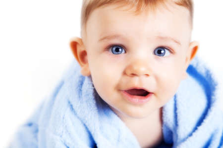 Baby boy with beautiful blue eyes over whiteの写真素材