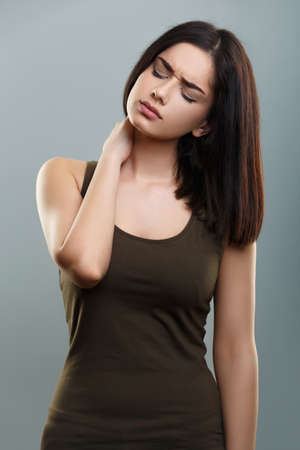 Young woman with neck painの写真素材