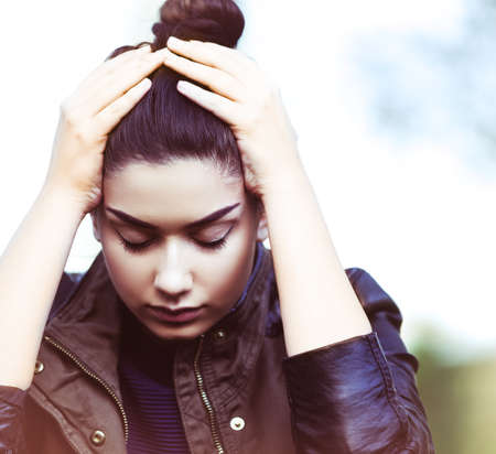 Sad depressed young teen woman outdoorsの写真素材