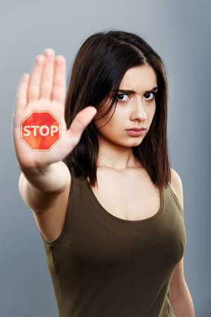 Domestic violence and abuse concept. Upset woman showing hand stop signの写真素材